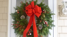 Christmas wreath with red ribbon white tipped cones